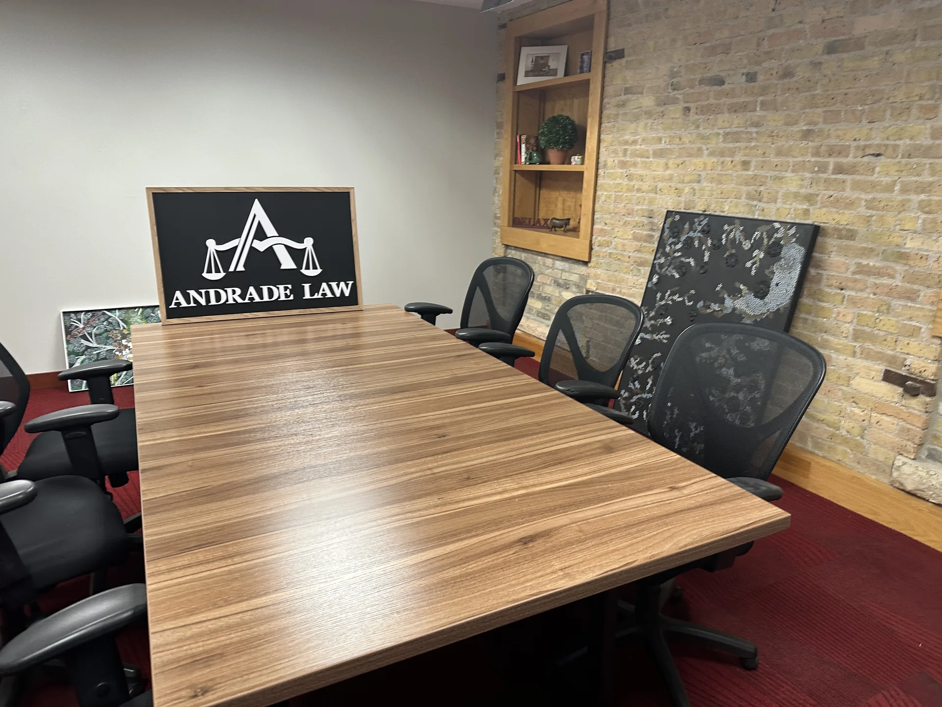 Conference room at Andrade Law's Minneapolis office, 10 S 5th St Suite 800, with the firm's framed sign