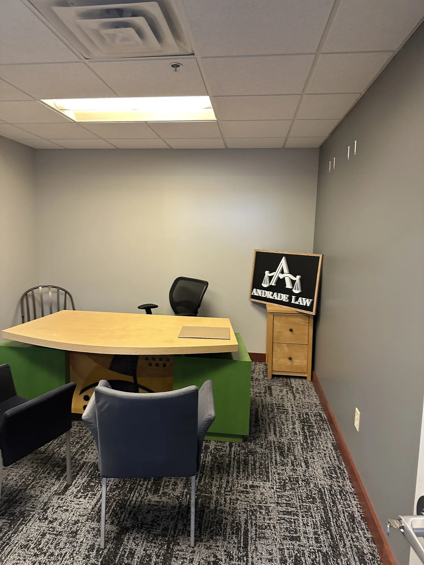 Meeting room at Andrade Law's Minneapolis office with the firm's framed sign
