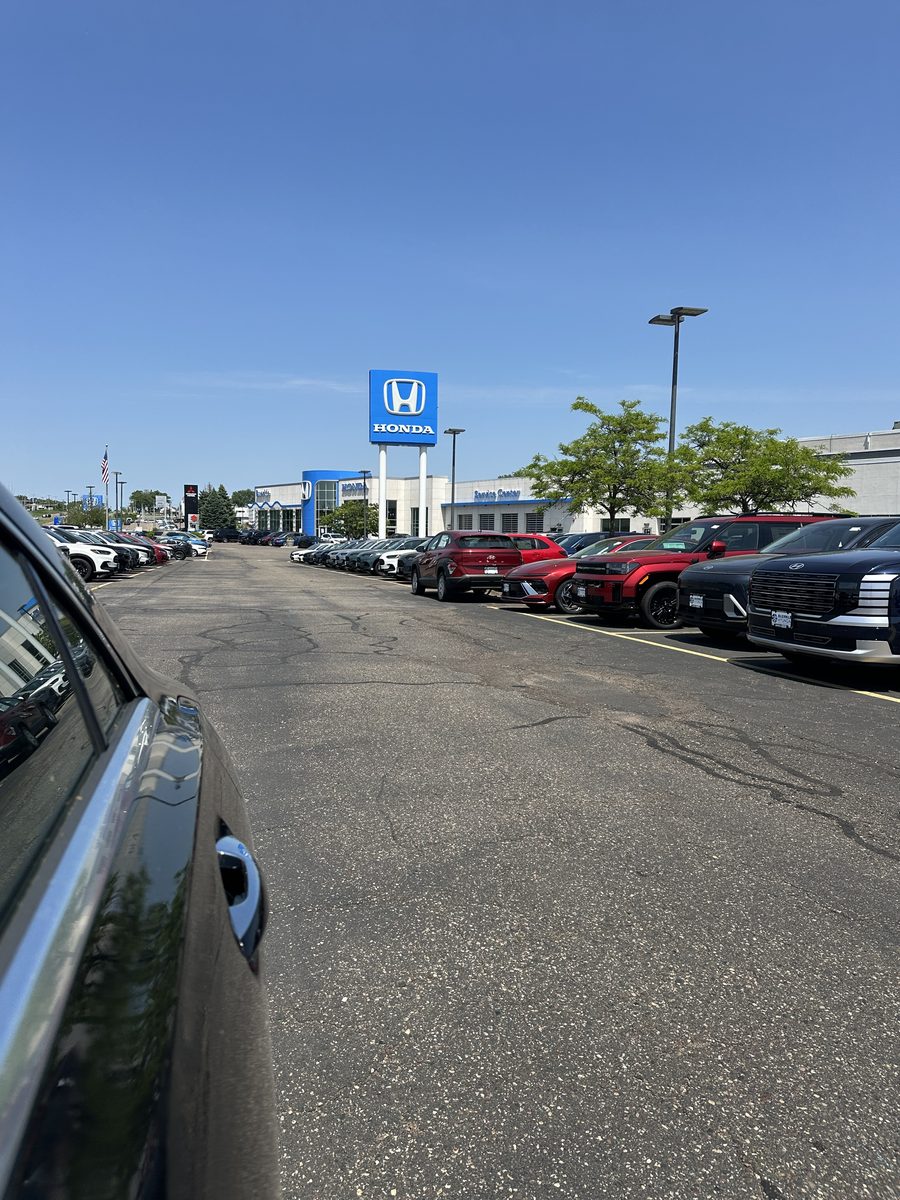 New-vehicle rows and the Honda pylon sign at Buerkle Honda on the Highway 61 corridor in Vadnais Heights, Minnesota